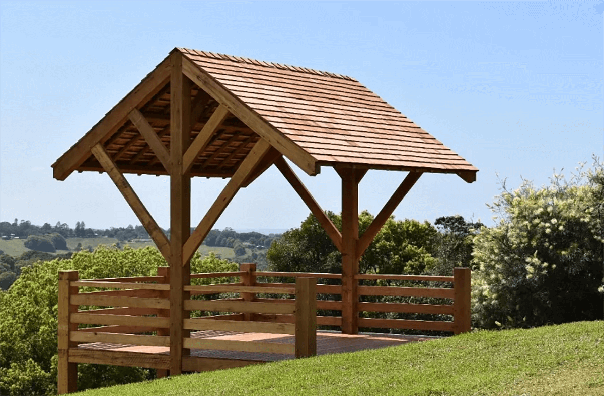 A traditional timber framed garden shelter and deck provides scenic views over the countryside